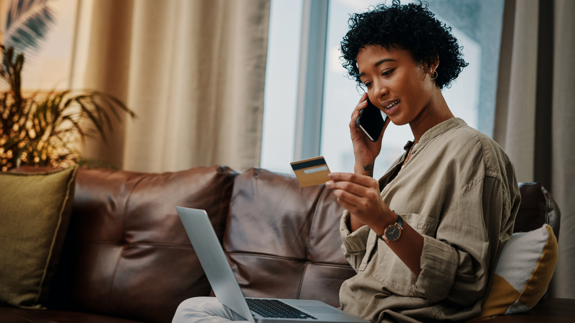 Une professionnelle consulte son ordinateur tout en échangeant au téléphone